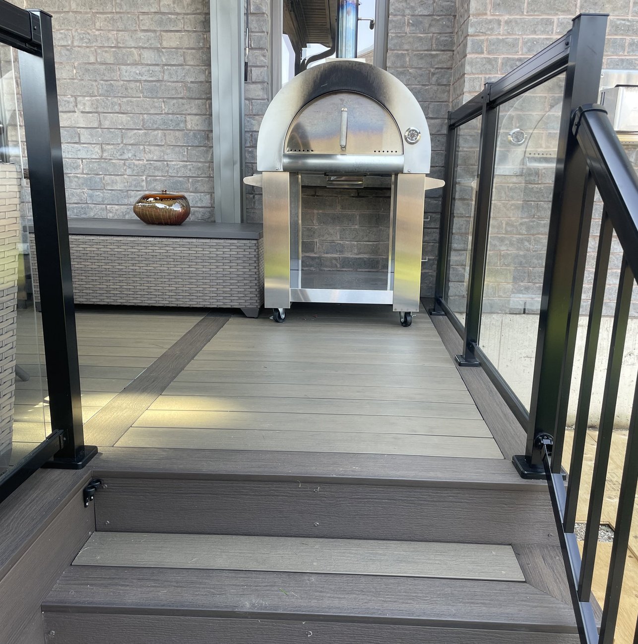 composite deck with glass railing and stairs built by Baird Construction in Woodstock ON
