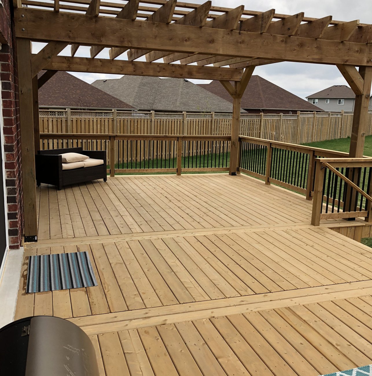 pressure treated wood deck with cedar pergola built by Baird Construction near Woodstock Ontario